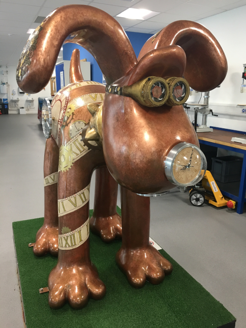 Statue of Gromit (from Wallace and Gromit) decorated with clocks