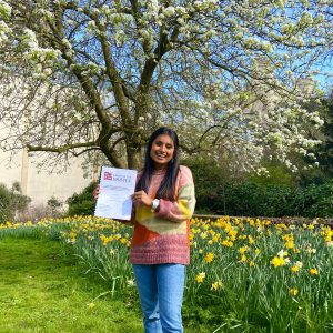 Jasmin in Royal Fort Gardens holding a printed dissertation